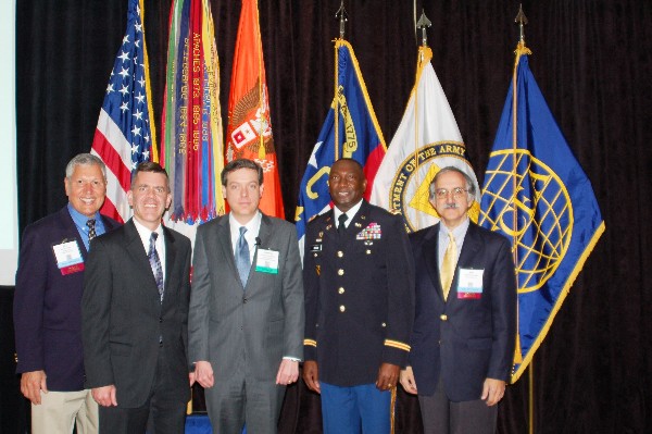 Johnathan Womer (c), chief information officer of North Carolina, delivers a presentation on cost cutting and innovation through technology at the chapter’s Symposium and Exposition in November. He is joined by (l-r) Bill Pope, chapter vice president for expositions; Reimers; Col. Sylvester Cotton, USA, assistant deputy chief of staff, G-6 United States Forces Command; and Phil Williams, chapter historian.